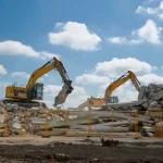 Excavators Clearing Debris at Demolition Site