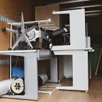 Disassembled office chair and workstation components prepared for relocation services