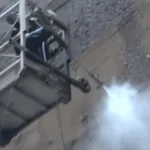 Industrial water spray system controlling dust during high-rise demolition operations