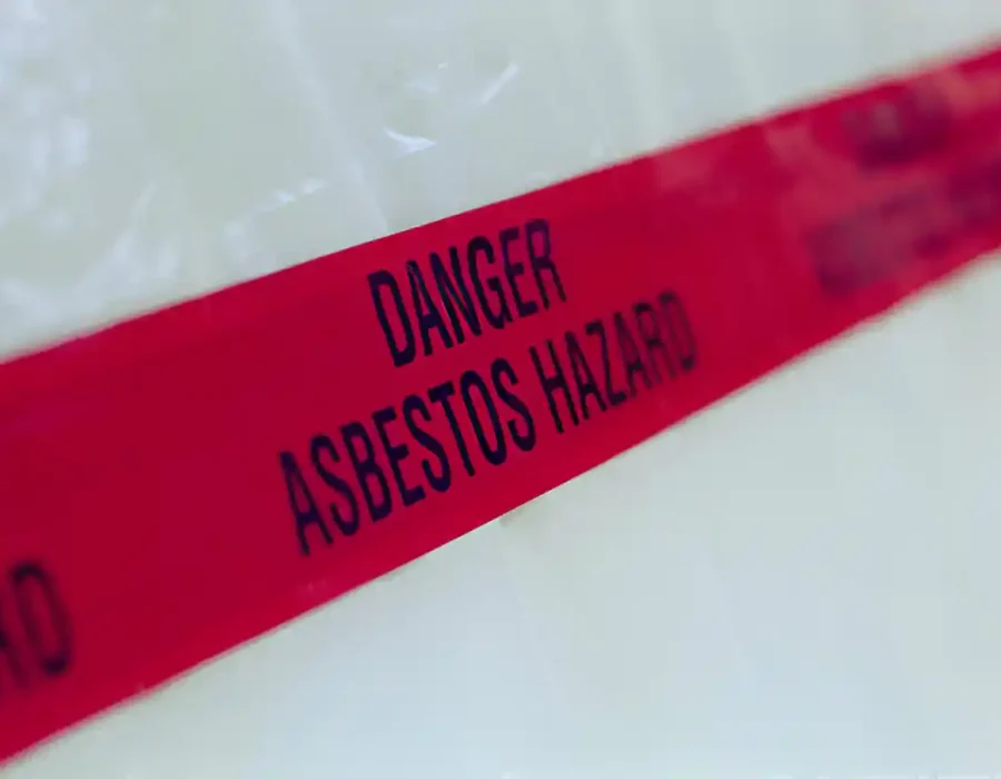 Warning tape marks asbestos hazard in a demolition site, ensuring safety compliance