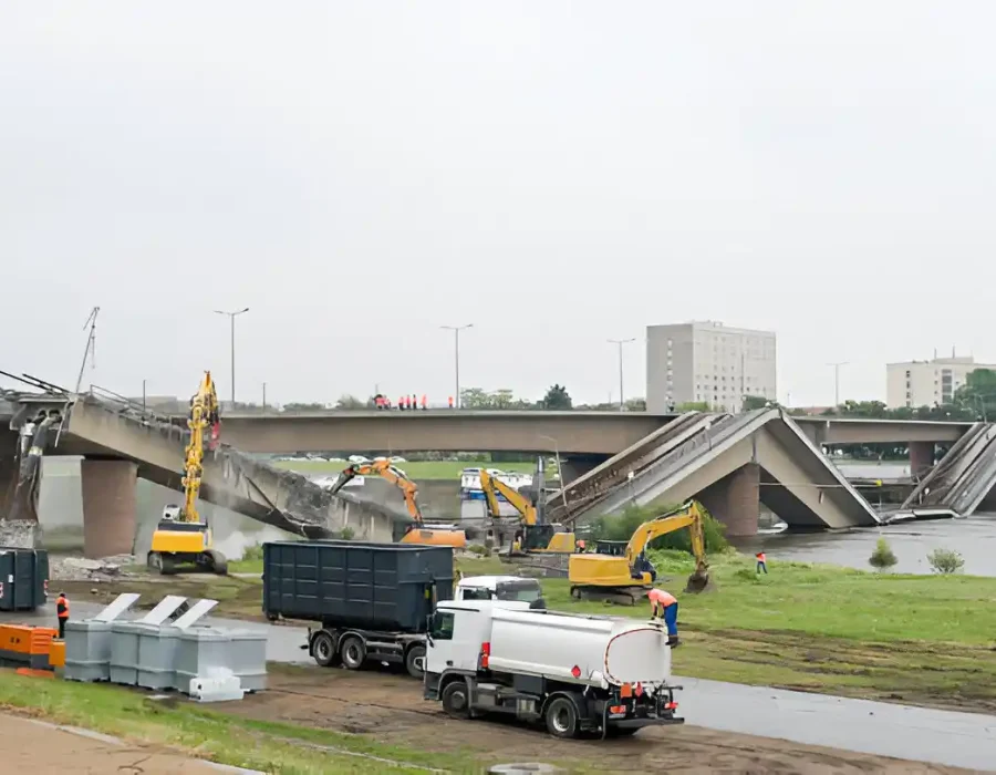 Heavy machinery removing brick rubble during structural demolition project