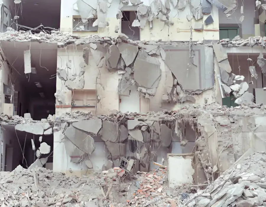 Extensive concrete structure collapse, revealing multi-level demolition and debris removal