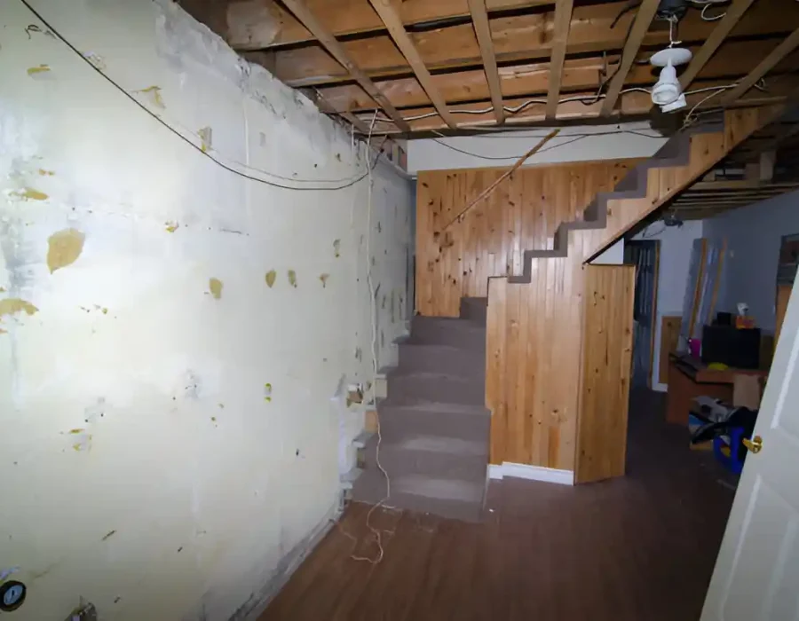 Basement Area with Exposed Ceiling and Stairs