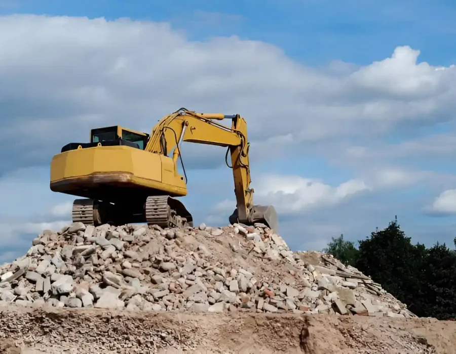 Excavator on Rubble for Demolition Cleanup