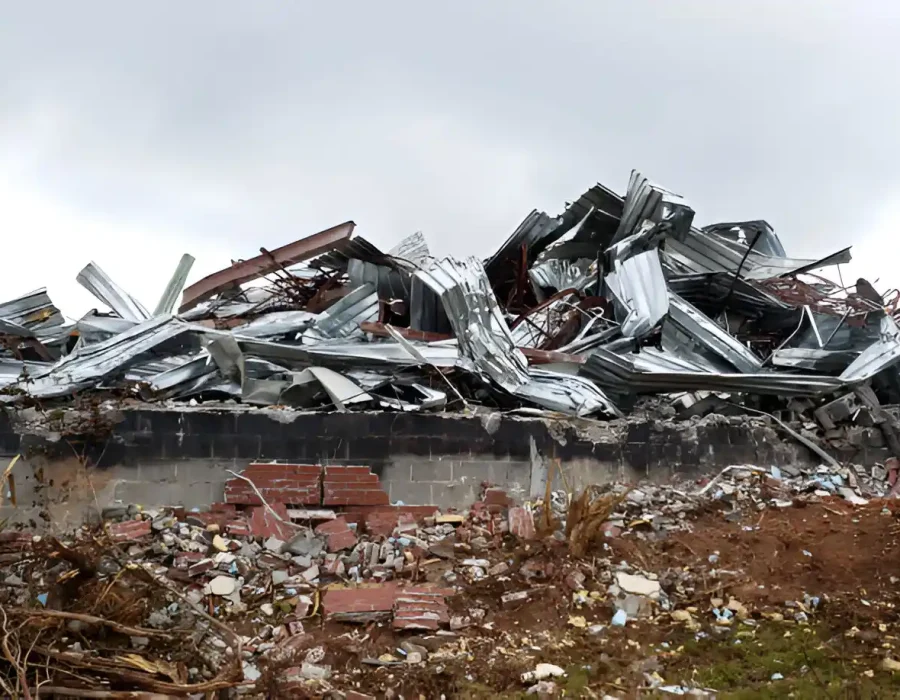 Pile of metal and brick debris from a collapsed building awaiting removal.