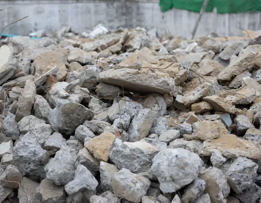 Concrete rubble pile from a building demolition site, ready for removal and cleanup.