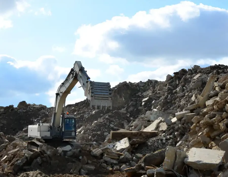 Excavator Sorting Rubble at Demolition Site