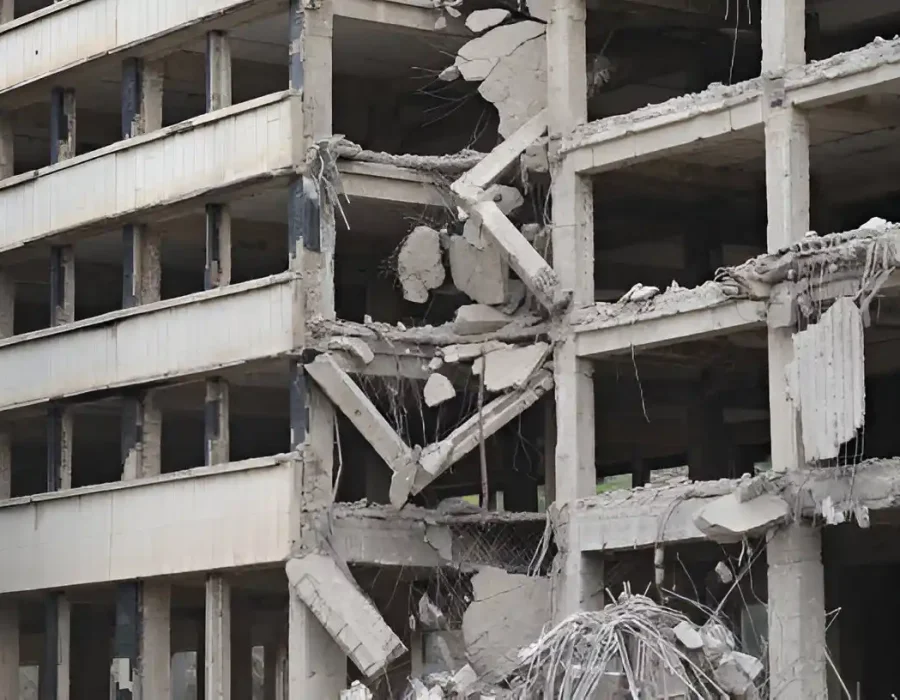 Partially demolished commercial building showing exposed concrete framework and structural removal