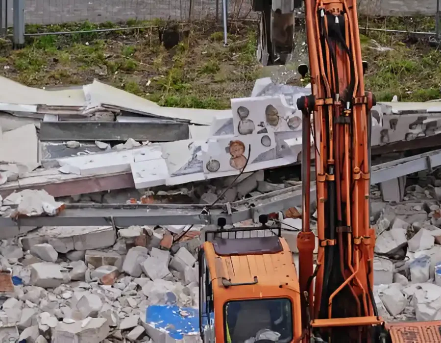 Orange Excavator at Major Building Demolition