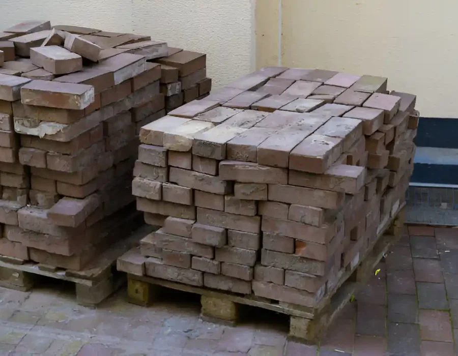 Pallets of reclaimed bricks from demolition site sorted and stacked for recycling and reuse
