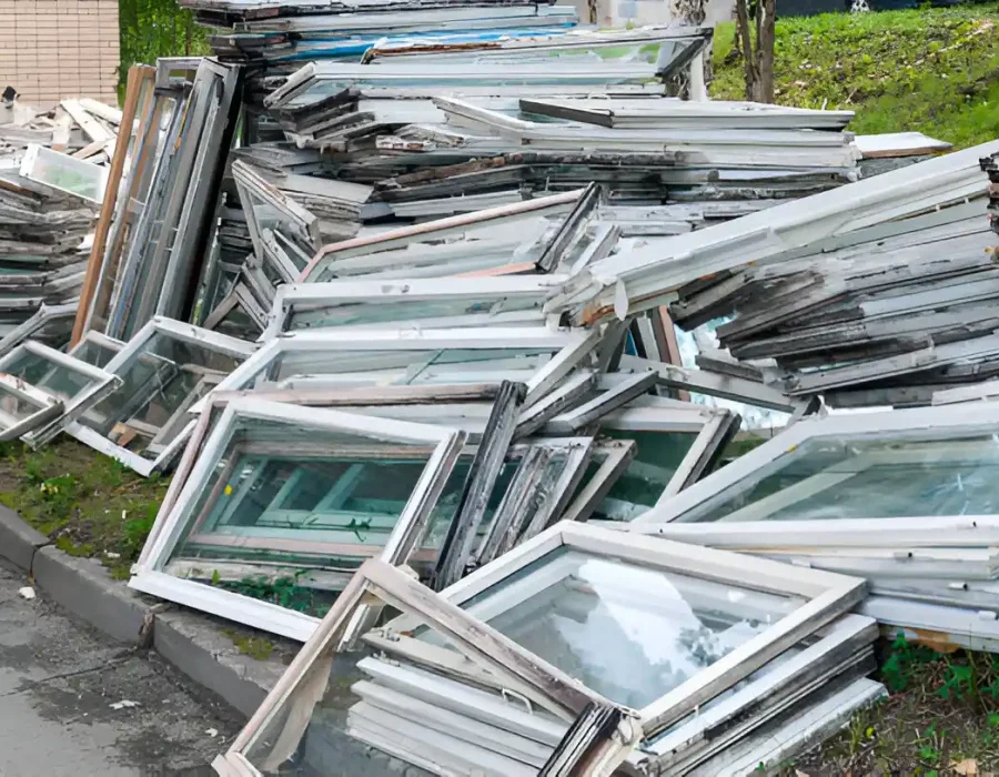 Pile of removed aluminum window frames and glass from building demolition ready for recycling