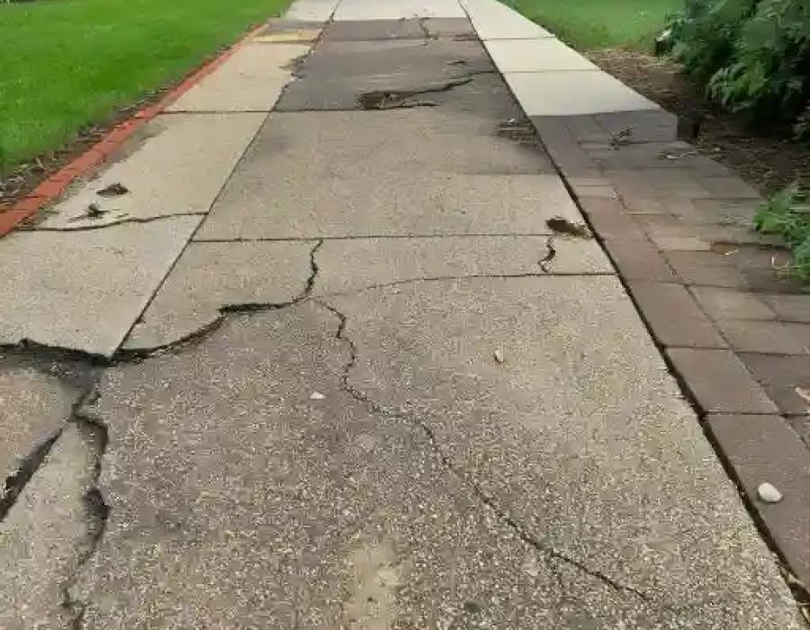 Damaged driveway with cracks needing repair services