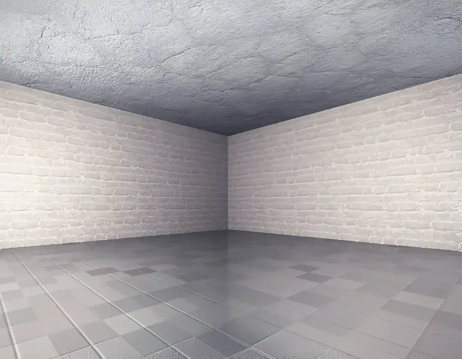 Empty room with white brick walls and gray tiled floor.