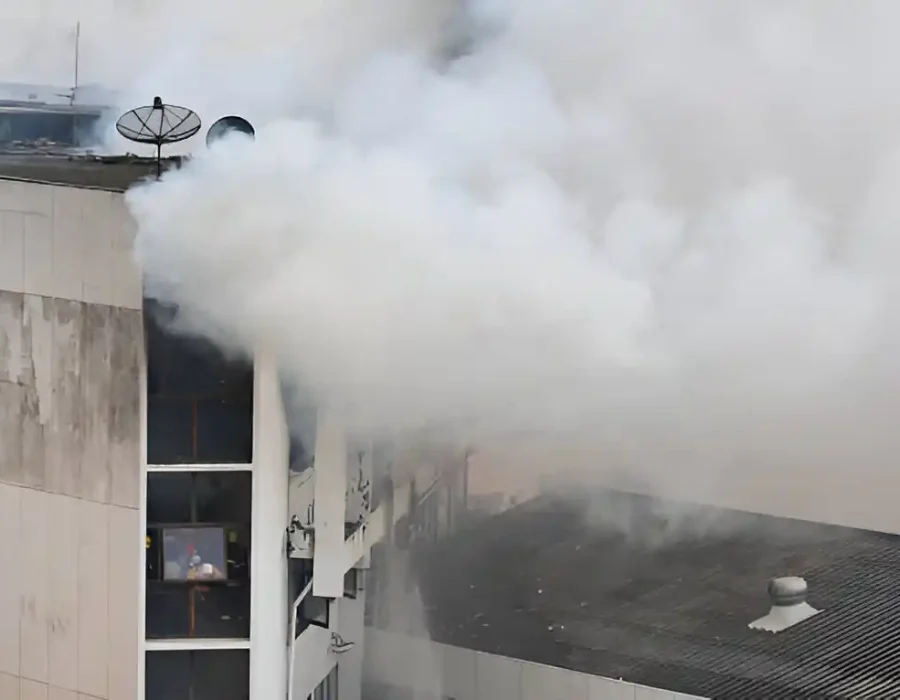 Thick smoke billowing from a damaged structure, indicating need for demolition and debris removal services.