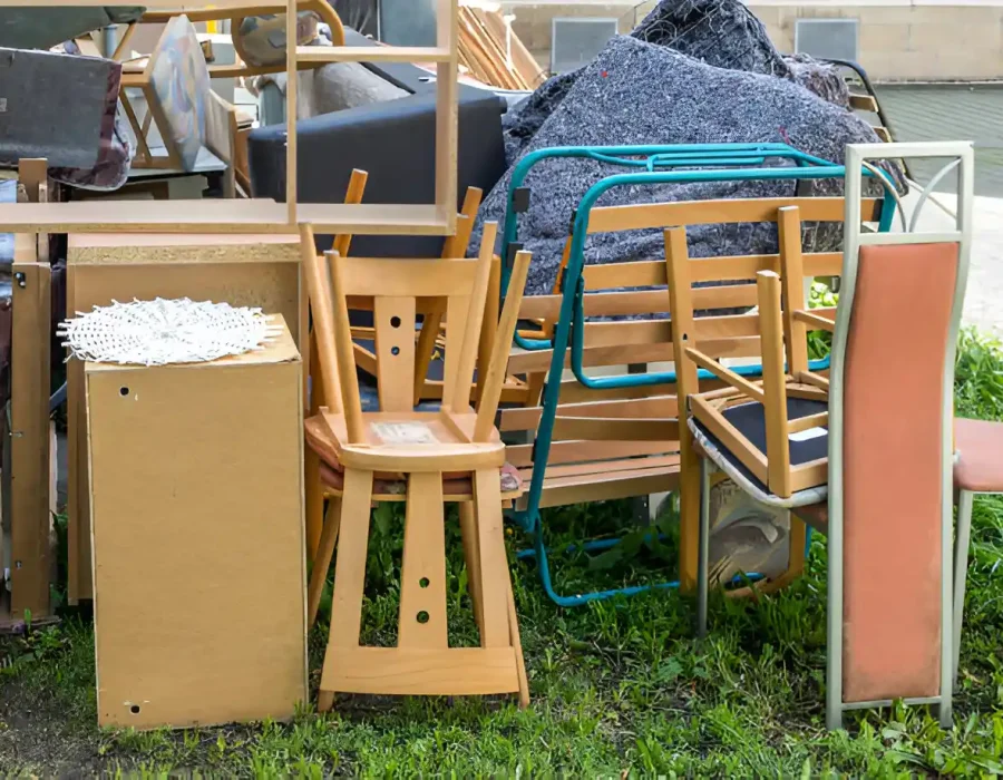 Stacked chairs and furniture awaiting removal for demolition and debris cleanup services