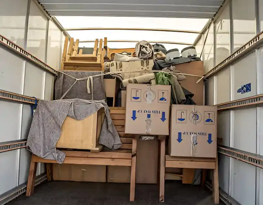 Moving truck loaded with furniture and boxes for demolition waste removal and construction debris hauling