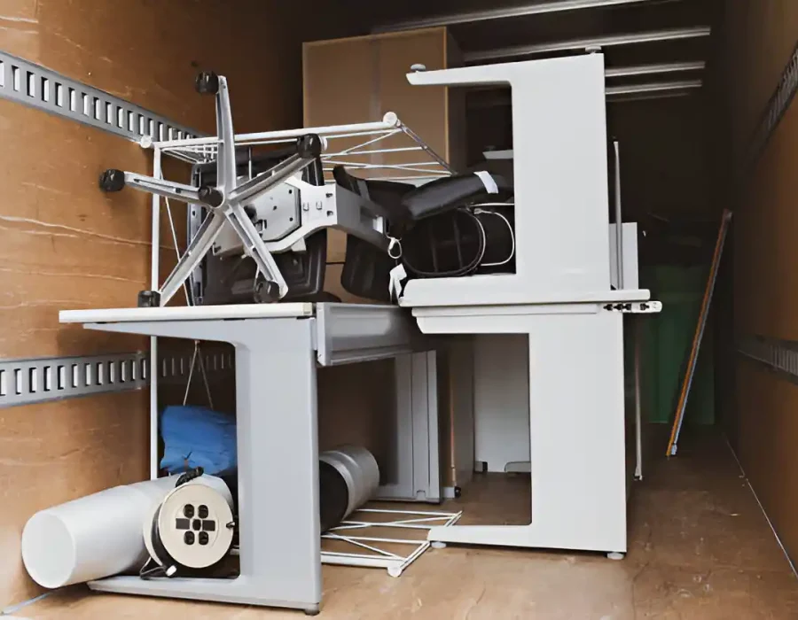 Dismantled office desk and equipment ready for commercial demolition and debris removal services