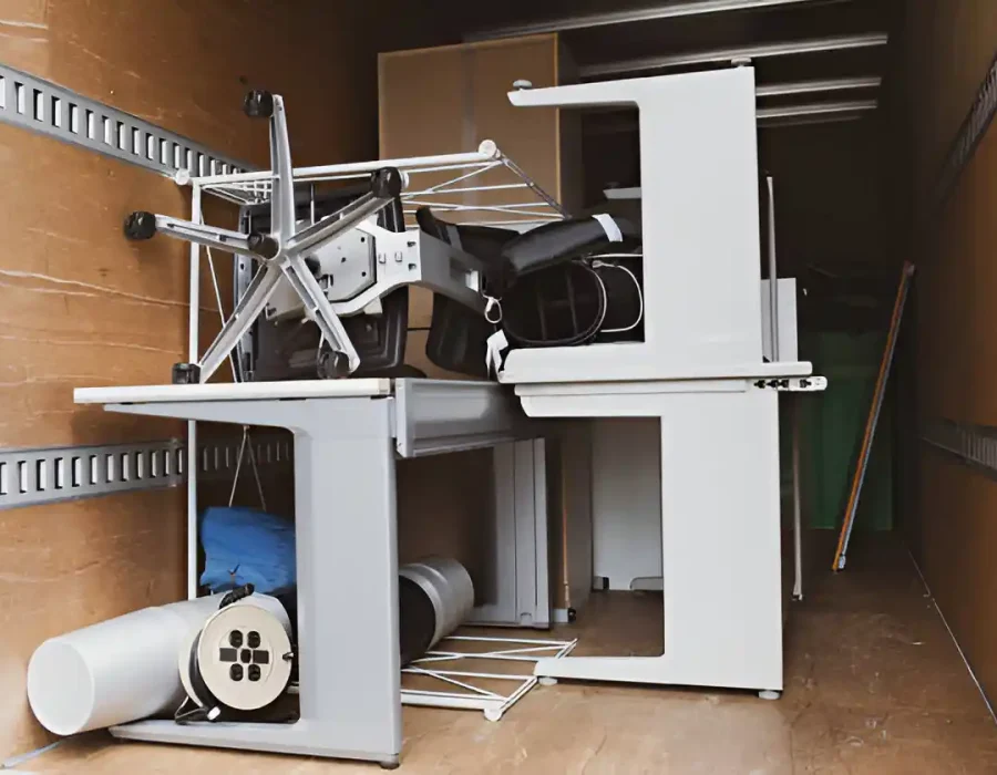 Disassembled office furniture and equipment in a truck for cleanup and debris removal services