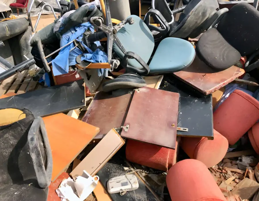 Mixed debris of office furniture and materials ready for demolition and cleanup services