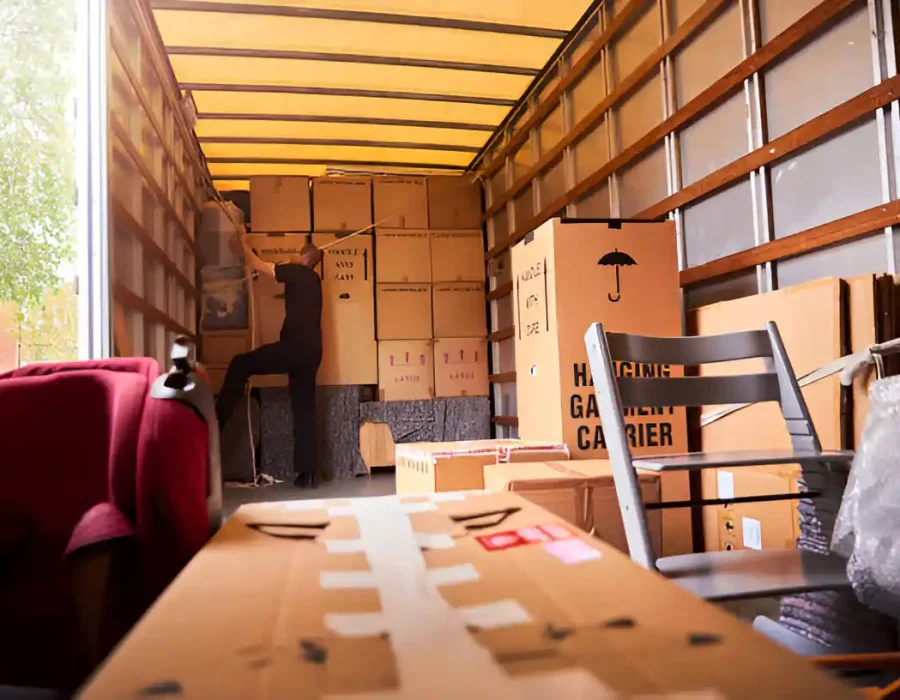 Moving truck interior loaded with cardboard boxes, furniture and packed items for residential cleanout service