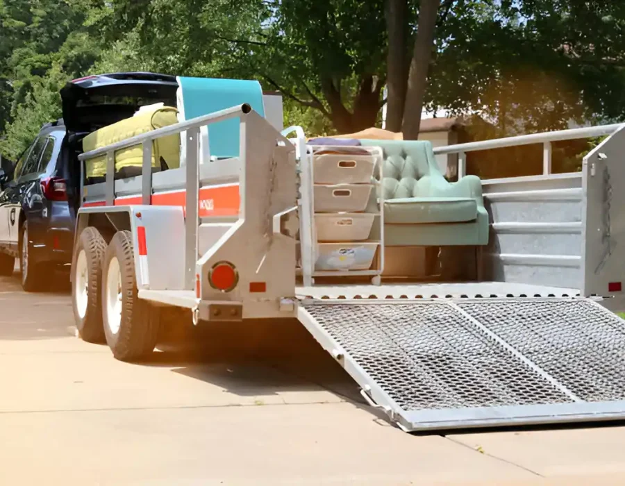 Furniture and storage bins loaded on a trailer for efficient debris removal and cleanup services