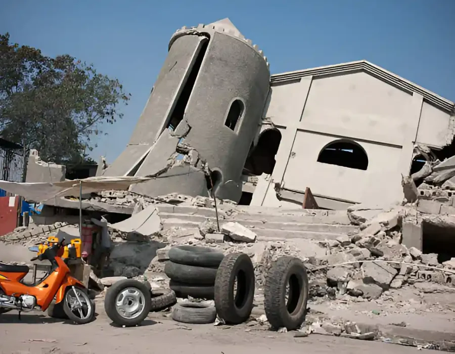 Earthquake-damaged church with fallen tower and scattered debris requiring professional demolition services