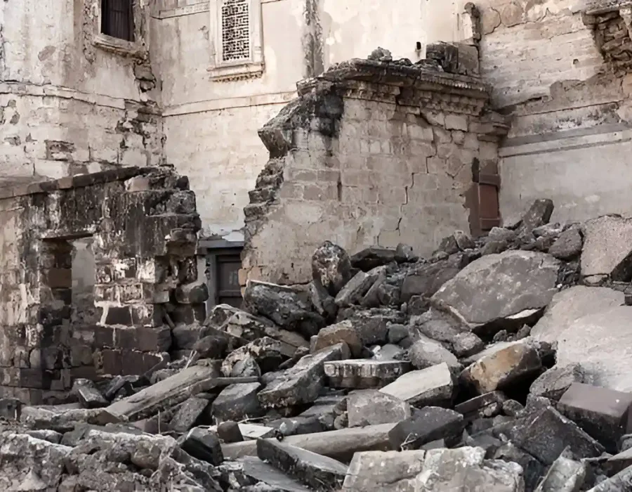 Rubble and damaged walls from a demolished building site.