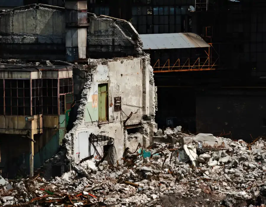 Partially Demolished Concrete Structure with Rubble and Exposed Walls
