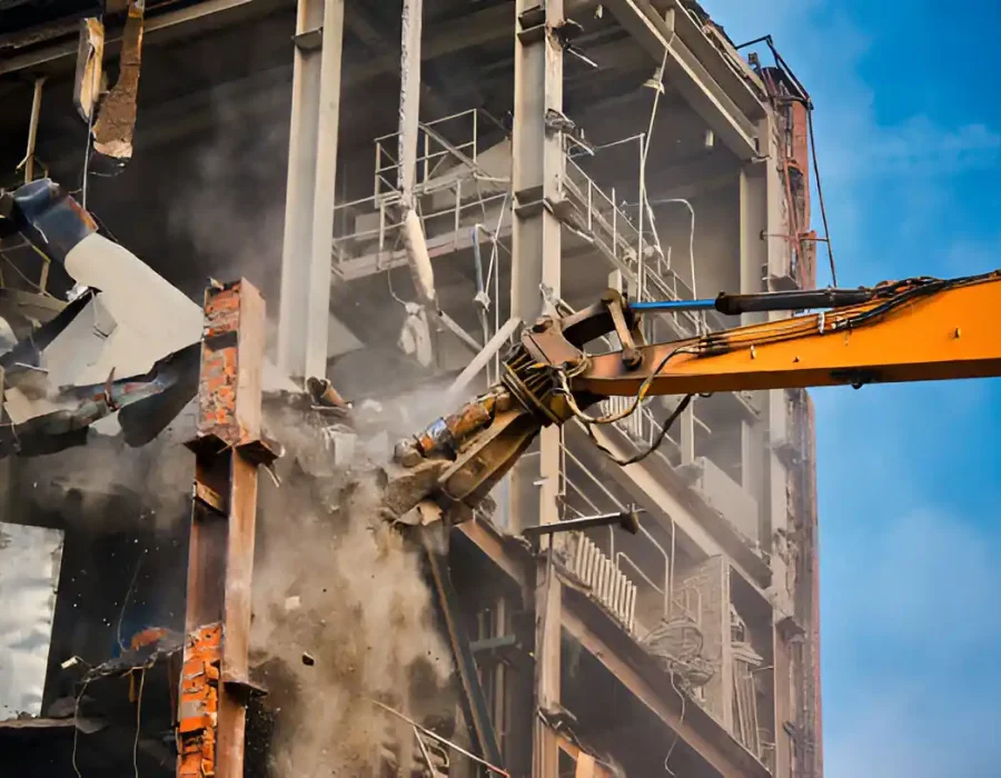Yellow Excavator Dismantling Multi-Story Building with Dust and Debris