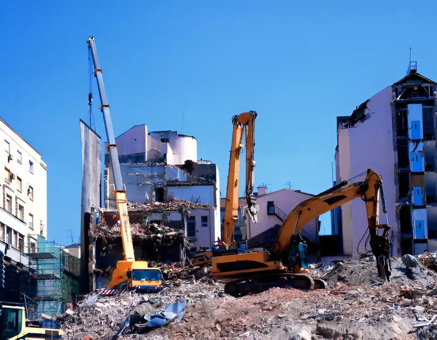 Excavators dismantling multi-story buildings with precision in urban environment