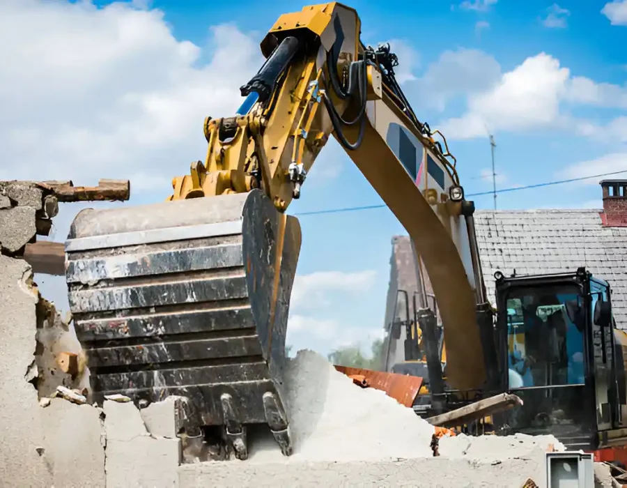 Heavy machinery breaking through wall with powerful hydraulic attachment