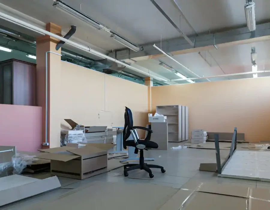 Empty office space with disassembled furniture and equipment ready for commercial removal service