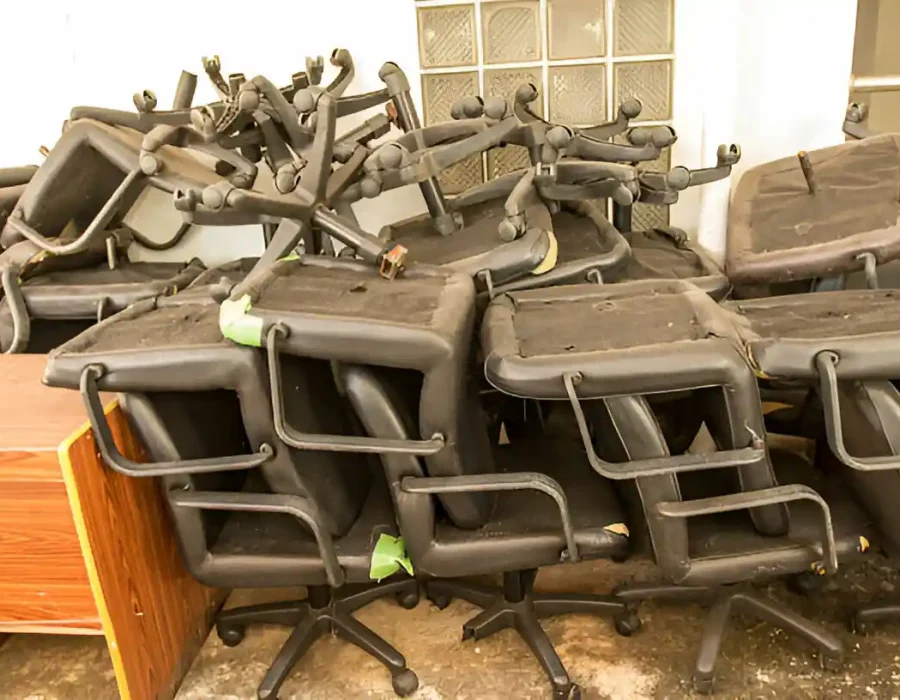 Stack of used office chairs ready for removal during commercial space clearance project