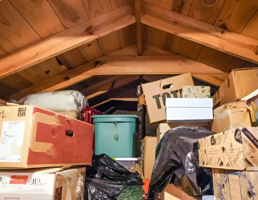 Cluttered garage storage area with boxes and containers requiring professional cleanout service