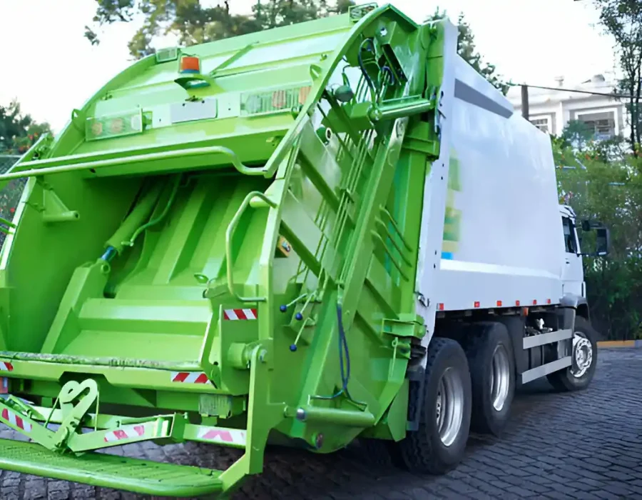Modern green garbage truck with hydraulic compactor system for efficient waste removal services