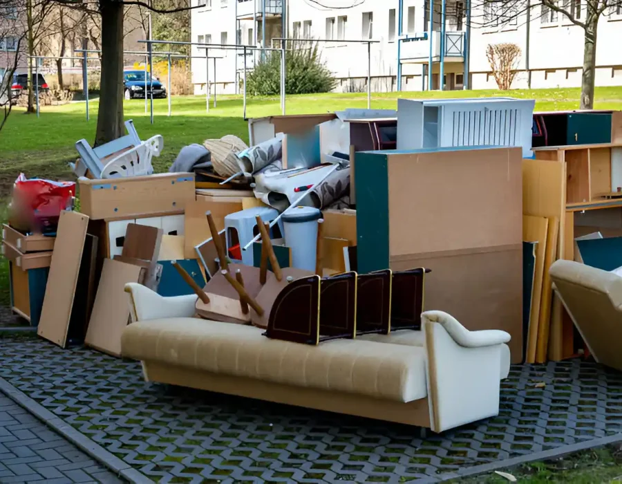 Discarded couch and furniture items at residential complex requiring professional removal services