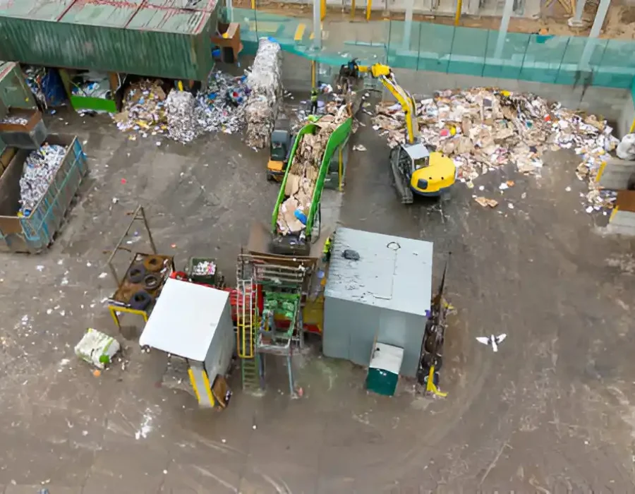 Aerial view of recycling facility with sorting equipment, conveyor belts and waste processing machinery