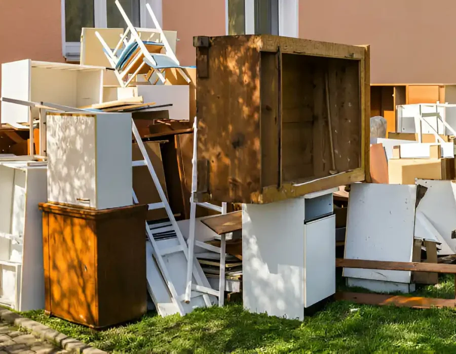 Discarded office cabinets, chairs, and furniture awaiting commercial junk removal services