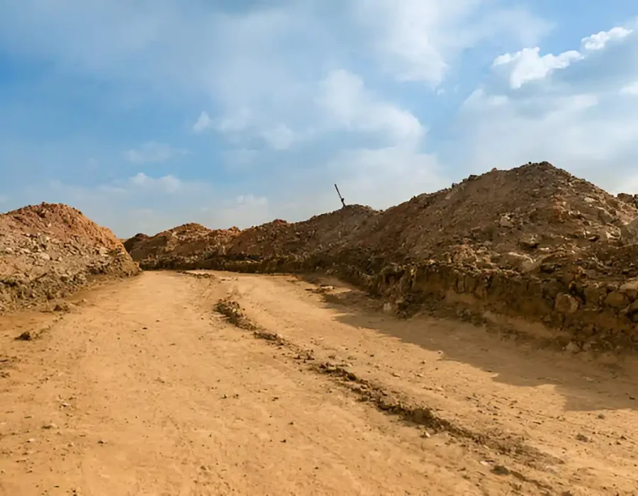 Cleared Dirt Path Between Debris Piles on Site