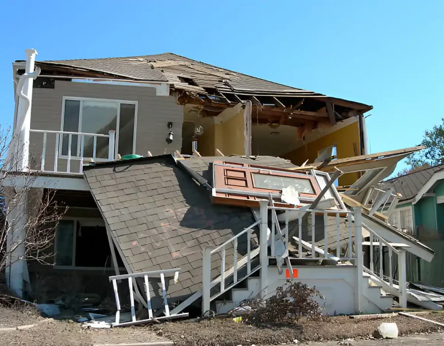 Severely burned room with smoke damage, debris, and destroyed interior walls