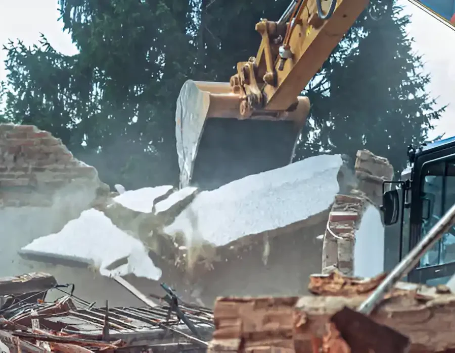Heavy machinery crushing concrete debris, professional site clearance and demolition service