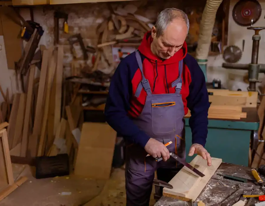 Woodworker Cutting Timber in Workshop