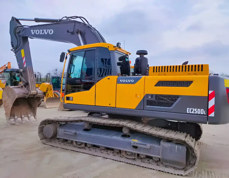 Yellow and gray Volvo EC250DL excavator parked on a construction site, ready for demolition tasks.
