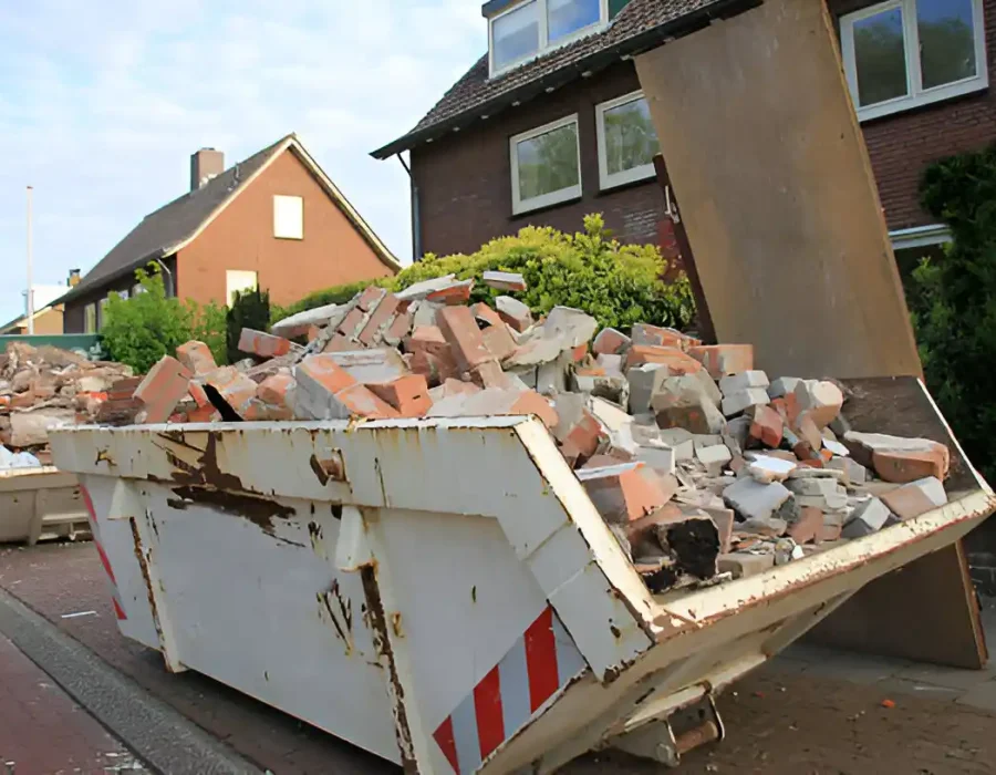 White dumpster filled with brick and concrete debris from home renovation project in residential area