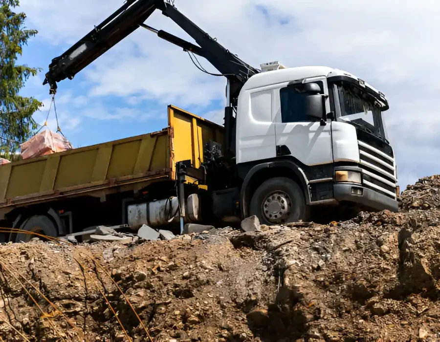 Crane Truck Loading Demolition Debris for Removal