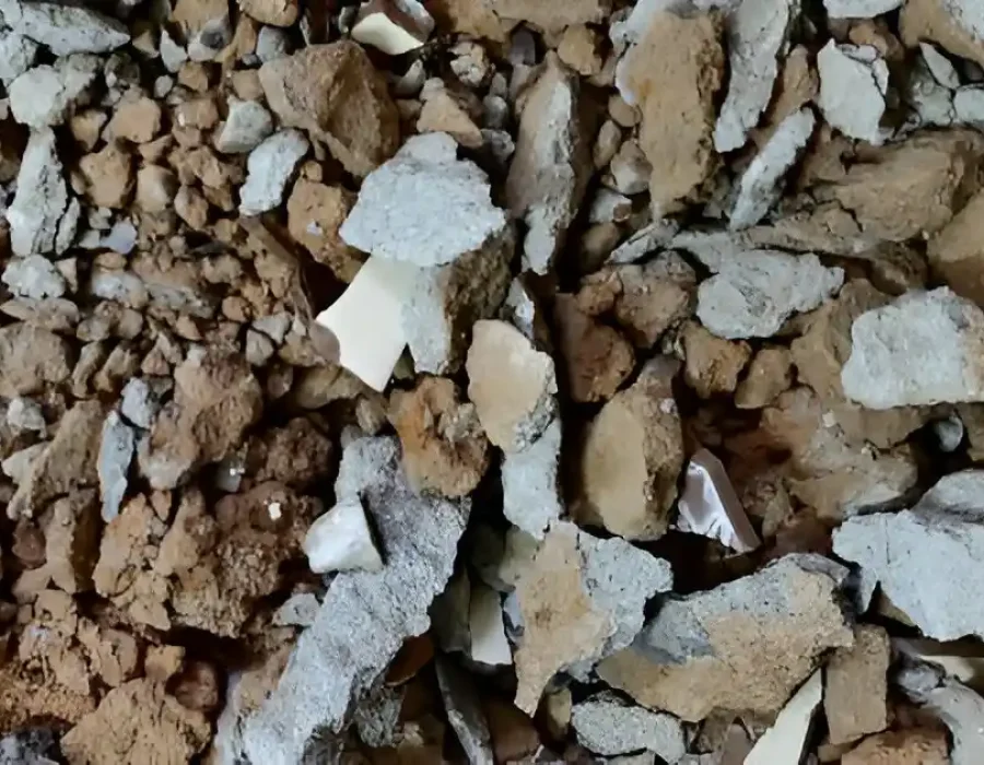 Close-up of mixed demolition rubble showing broken concrete, drywall, and construction waste