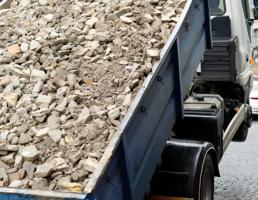 Close-up of roll-off dumpster filled with concrete and masonry debris from demolition project