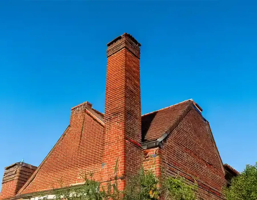 Brick Chimney on Old House for Demolition