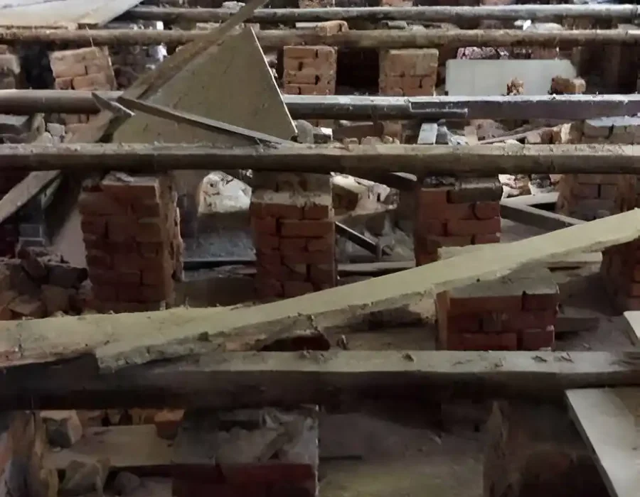 Exposed floor structure with debris for cleanup and removal services