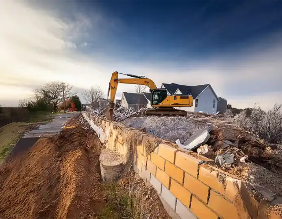 Heavy equipment demolishing a building and removing debris, showcasing efficient demolition and cleanup solutions.